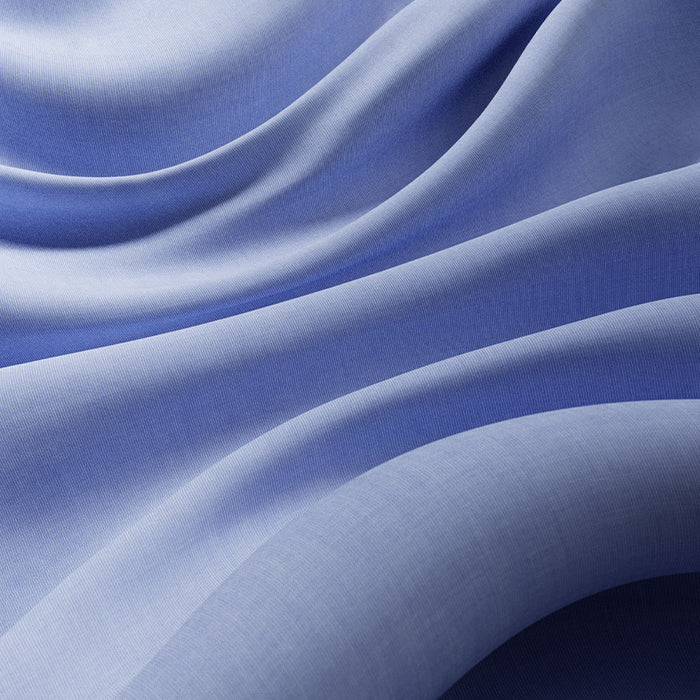 Soft blue fabric falling in fluid folds