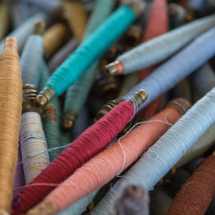 Colourful spindles of fine thread