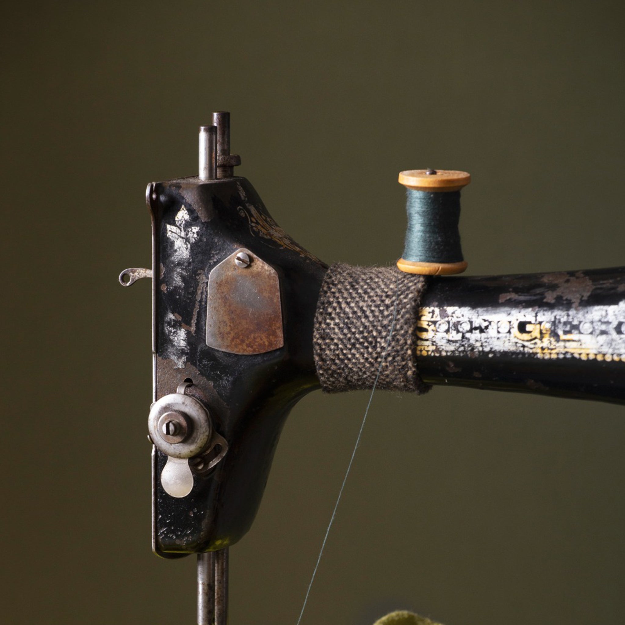 Vintage sewing machine with green thread