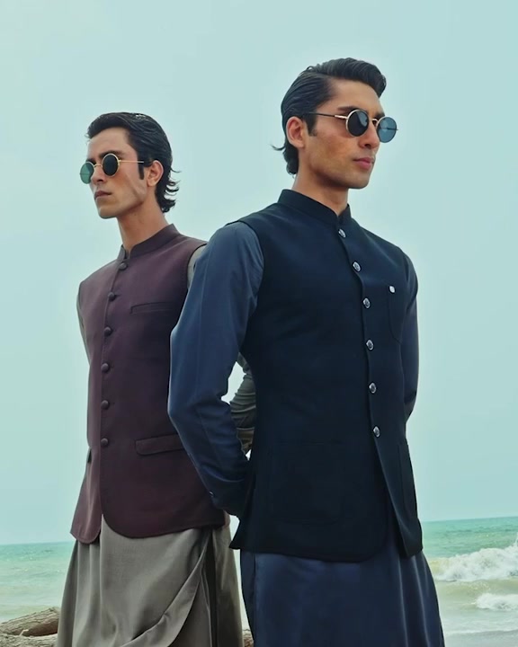 Models wearing contemporary shalwar qameez by the sea